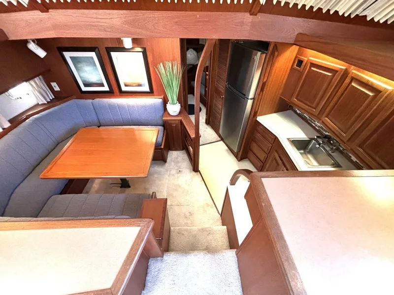 Slide: The Image of Interior of a 1987 Viking Motor Yacht with wood furnishings and blue upholstery. - 46