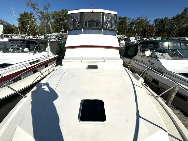 Slide: The Image of A 1987 Viking Motor Yacht docked in a marina, surrounded by other boats. - 12