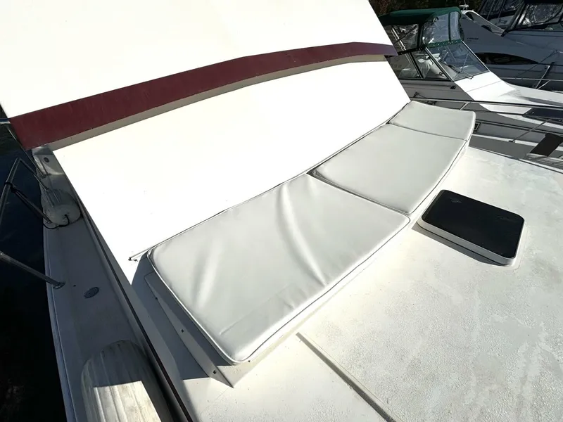 Slide: The Image of A 1987 Viking Motor Yacht with white cushions on the deck, surrounded by other boats. - 14
