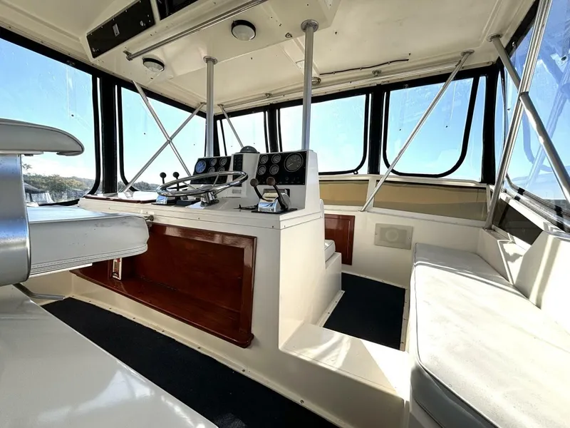 Slide: The Image of Interior of a 1987 Viking Motor Yacht with helm station and seating area. - 26