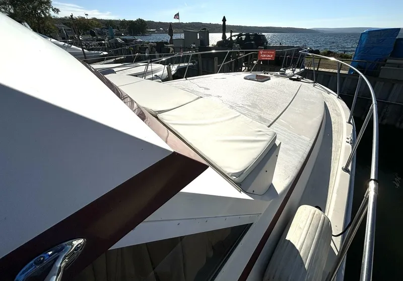 Slide: The Image of A 1987 Viking Motor Yacht docked at a marina. It features a spacious deck and is well-maintained. - 15