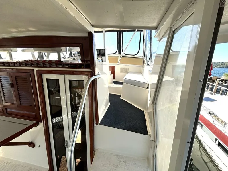 Slide: The Image of Interior view of a 1987 Viking Motor Yacht with wooden doors and white walls. - 25