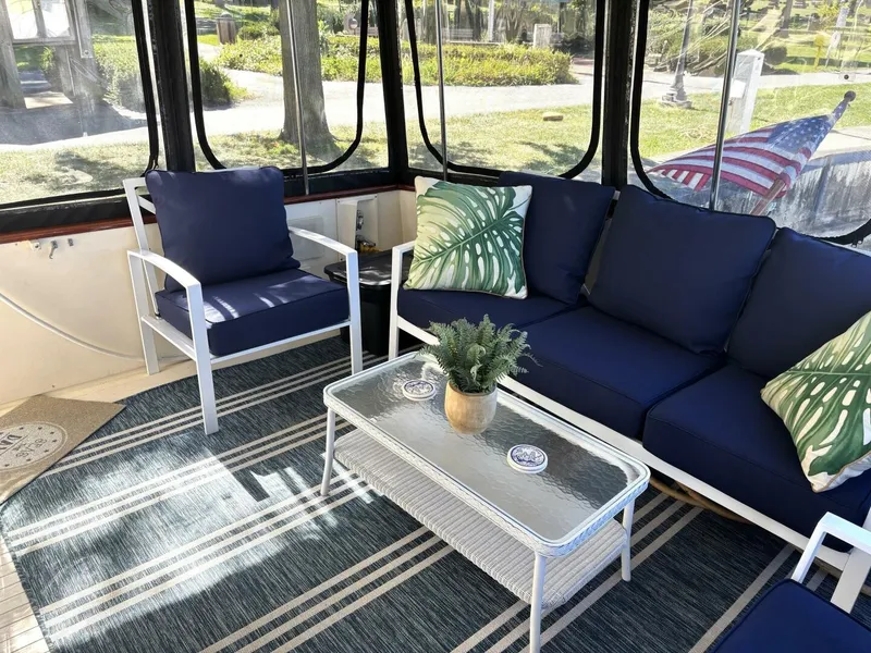 Slide: The Image of The image shows a yacht seating area with blue cushions and a glass table. - 22