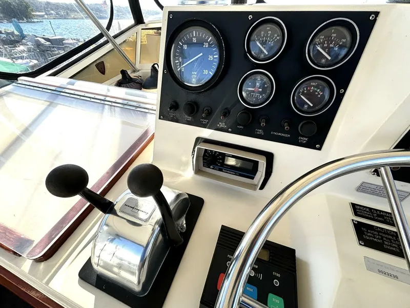 Slide: The Image of The image shows the helm of a 1987 Viking Motor Yacht with gauges and throttle controls. - 31