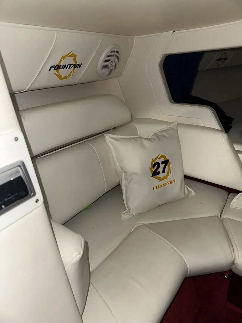 Slide: The Image of Interior of the 2005 Fountain 27 Fever with white upholstery and a logo pillow. - 14