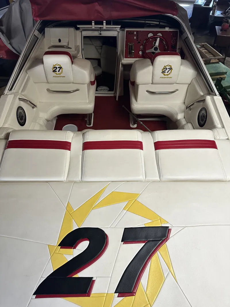 Slide: The Image of Interior of a 2005 Fountain 27 Fever with white seats and red accents. - 8