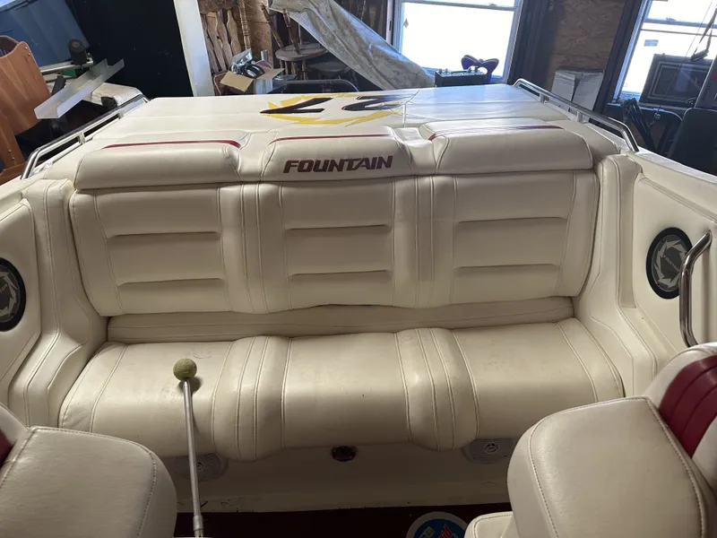 Slide: The Image of The image shows the cockpit of a 2005 Fountain 27 Fever with white upholstery and speakers. - 9