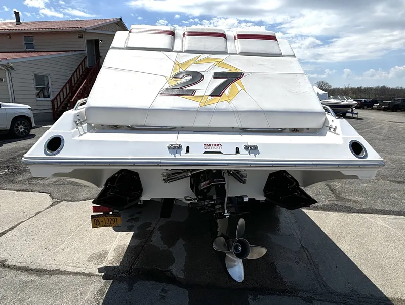 Slide: The Image of The image shows the rear of a 2005 Fountain 27 Fever boat with dual engines. - 3