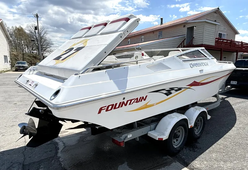 Slide: The Image of A white 2005 Fountain 27 Fever boat is on a trailer, featuring bold graphics. - 4