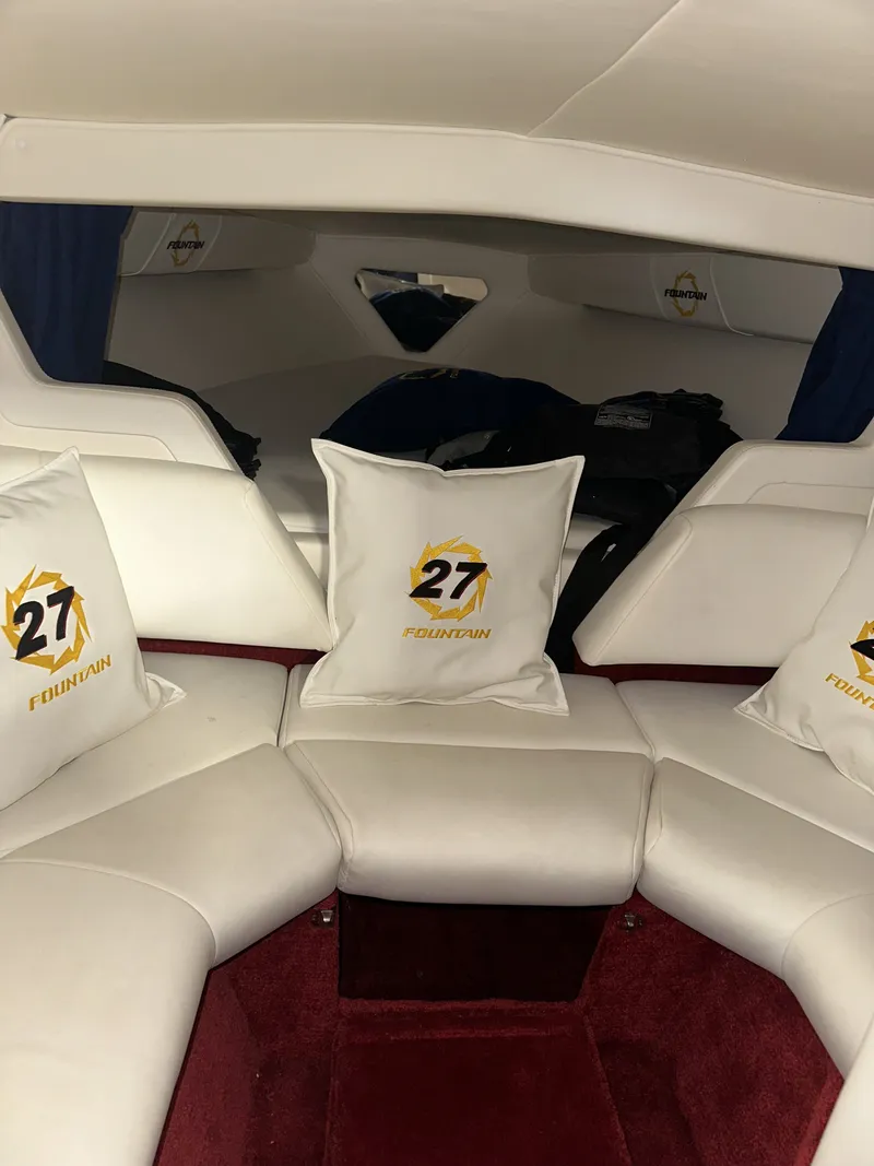 Slide: The Image of Interior of a 2005 Fountain 27 Fever with white upholstery and red carpeting. - 13