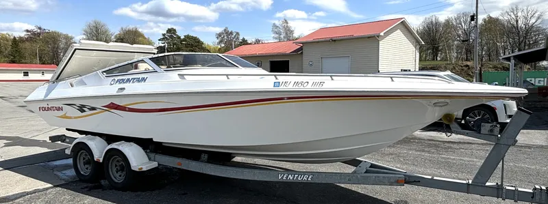 Slide: The Image of A white boat on a trailer with red and yellow stripes. - 6