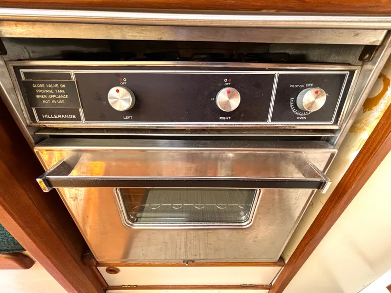 Slide: The Image of A stove with two dials and an oven in a boat. - 37