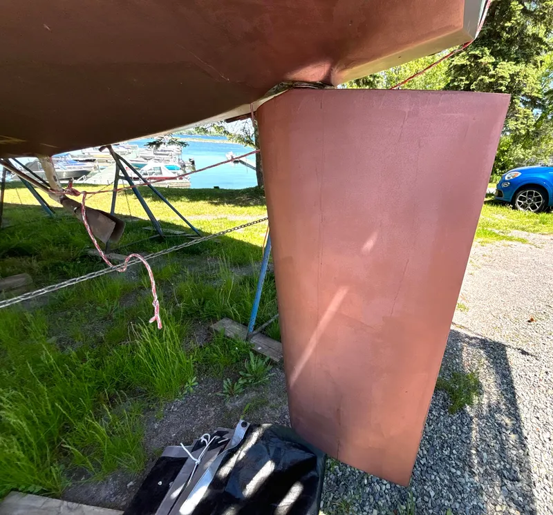 Slide: The Image of Rudder of a 1985 Nonsuch 30 Ultra on a boat storage lot. - 14