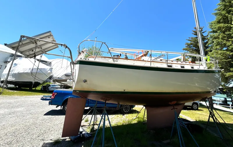 Slide: The Image of A 1985 Nonsuch 30 Ultra sailboat is on stands in an outdoor storage area. - 5