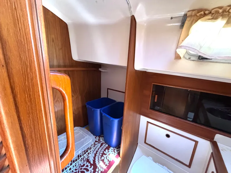 Slide: The Image of Interior of the 1985 Nonsuch 30 Ultra with wood paneling and storage space. - 44