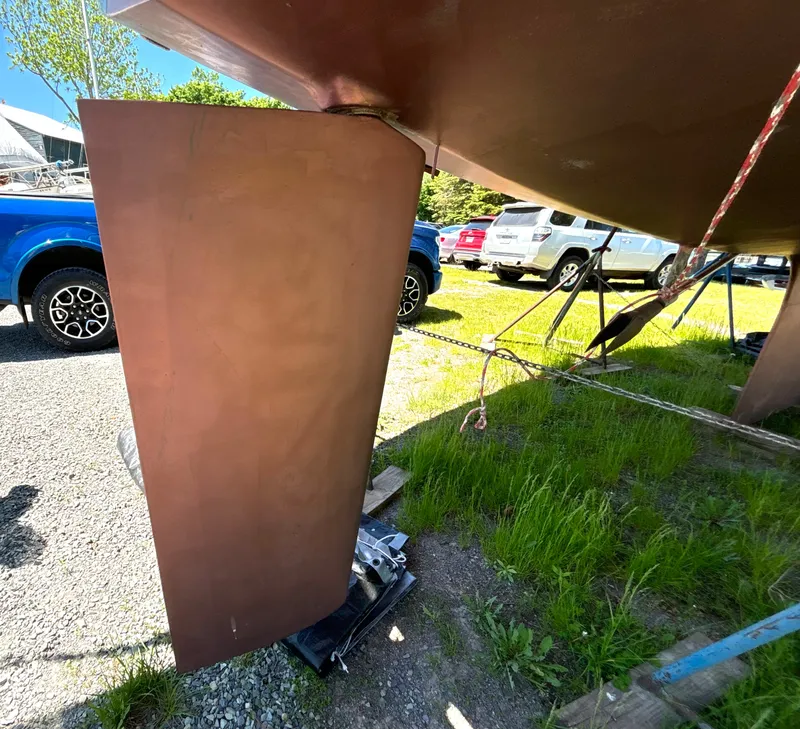 Slide: The Image of Rudder of a 1985 Nonsuch 30 Ultra on a boat storage lot. - 11