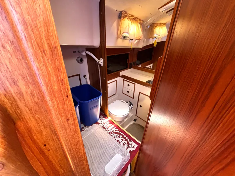 Slide: The Image of Interior of a 1985 Nonsuch 30 Ultra with wood paneling and a small sink. - 45