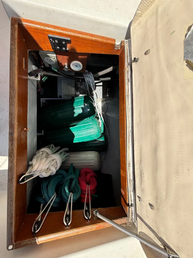 Slide: The Image of Storage compartment with ropes and fenders on a 1985 Nonsuch 30 Ultra boat. - 30