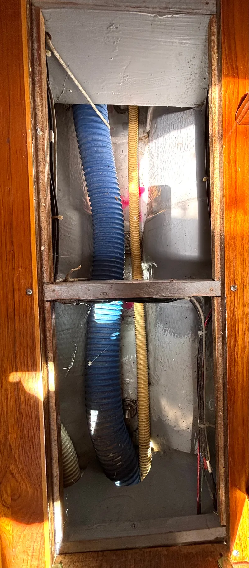 Slide: The Image of View of a 1985 Nonsuch 30 Ultra interior with visible hoses and wiring. - 47