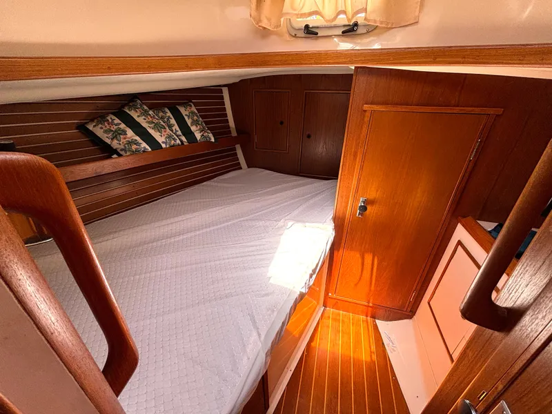 Slide: The Image of Cabin of the 1985 Nonsuch 30 Ultra with wooden walls and a cozy bed. - 40