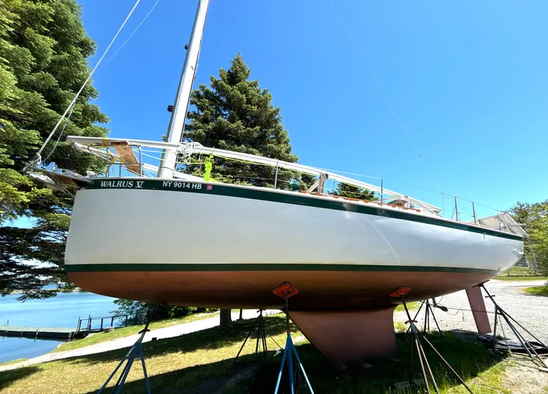 The Image of A 1985 Nonsuch 30 Ultra sailboat is on a stand on land. - 1