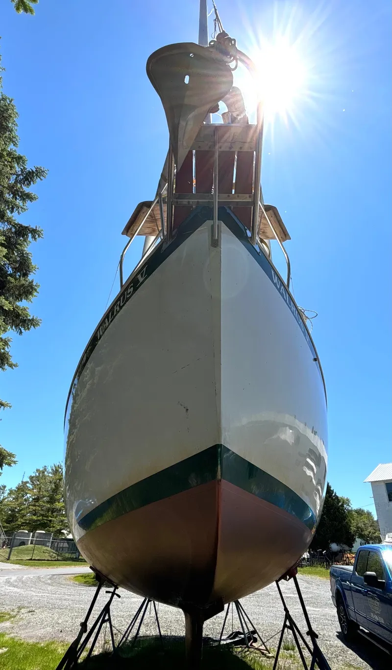 Slide: The Image of A 1985 Nonsuch 30 Ultra is on land, with the sun shining in the background. - 3