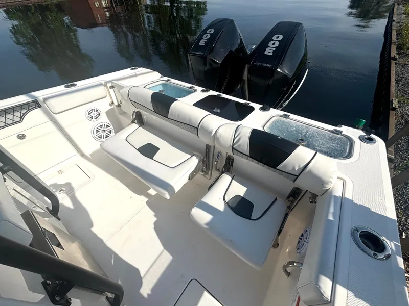 Slide: The Image of The image shows the cockpit of a 2019 Wellcraft 302 Center Console boat with two engines. - 16