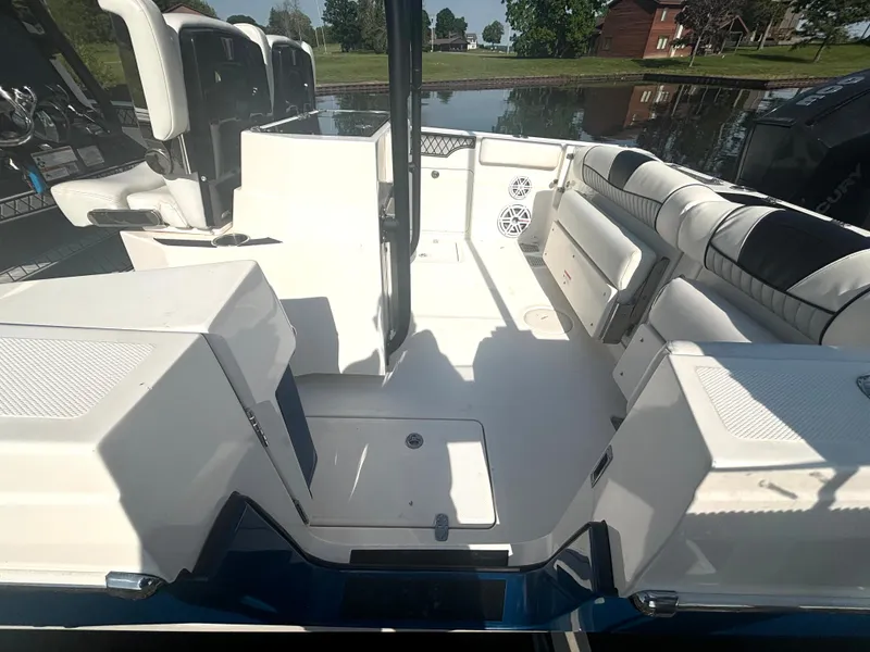Slide: The Image of The image shows the cockpit of a 2019 Wellcraft 302 Center Console boat. - 14