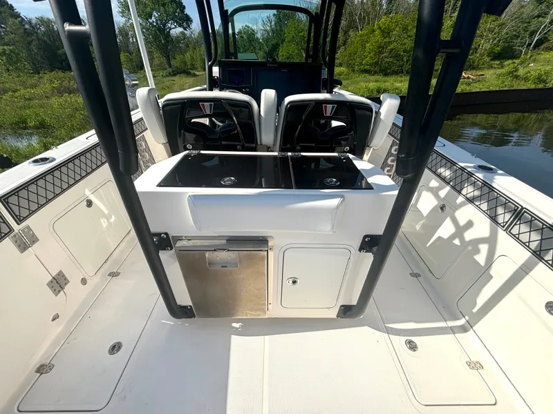 Slide: The Image of The image shows the cockpit of a 2019 Wellcraft 302 Center Console boat with two seats and a helm. - 19