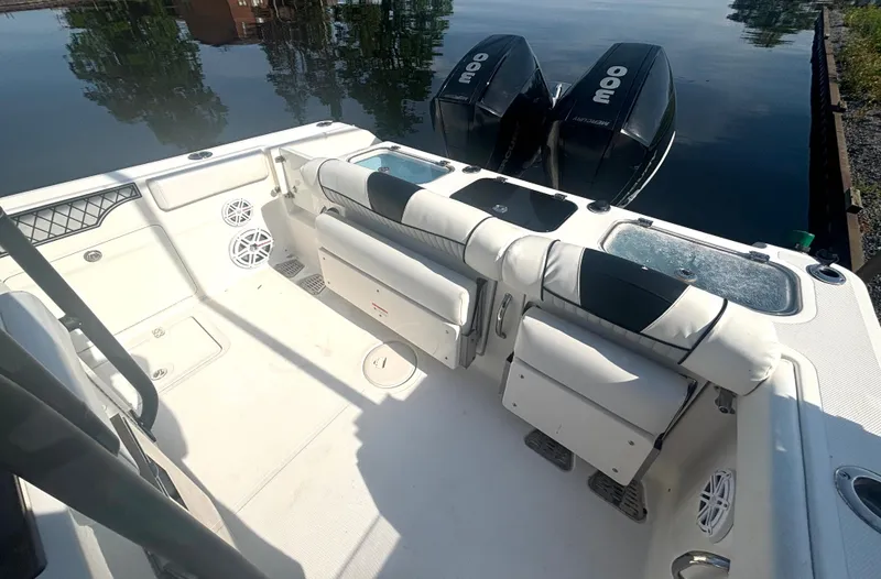 Slide: The Image of The image shows the cockpit of a 2019 Wellcraft 302 Center Console boat with two outboard engines. - 15
