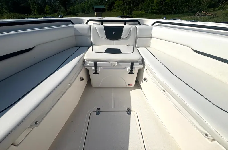 Slide: The Image of The image shows the bow of a 2019 Wellcraft 302 Center Console boat with white upholstery. - 34