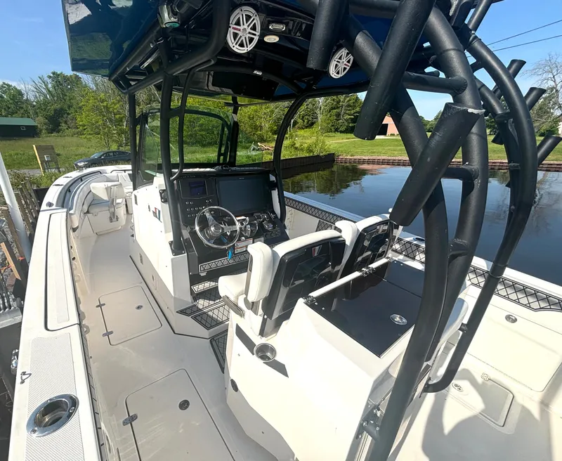 Slide: The Image of The image shows a 2019 Wellcraft 302 Center Console boat with a modern cockpit and helm. - 20