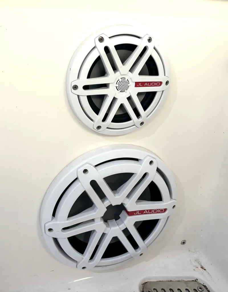 Slide: The Image of Two white JL Audio speakers are mounted on the wall of a boat. - 41