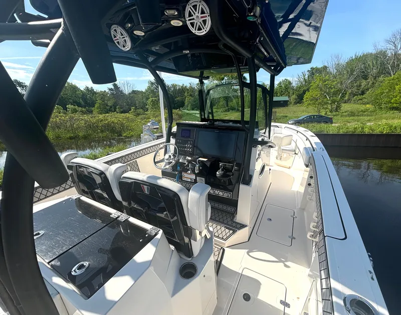 Slide: The Image of The image shows a 2019 Wellcraft 302 Center Console boat with modern features. - 21