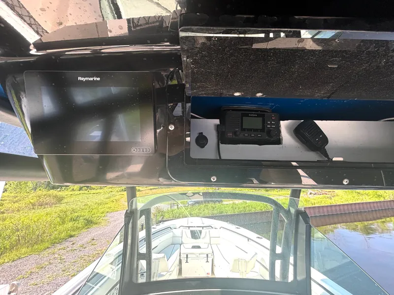 Slide: The Image of The image shows the cockpit of a 2019 Wellcraft 302 Center Console boat with electronics. - 29
