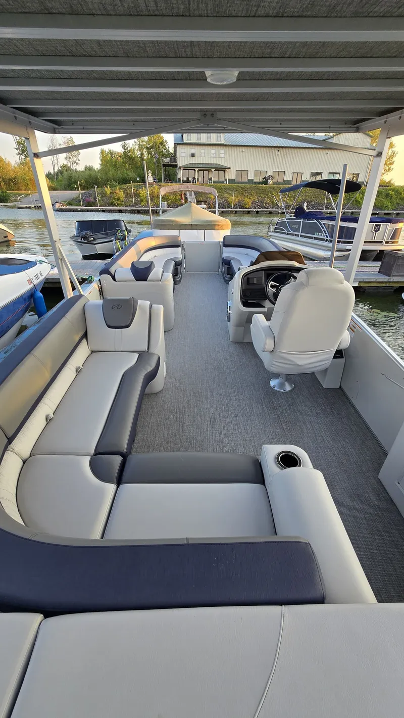 Slide: The Image of The image shows the interior of a 2023 Avalon Catalina 2585 CRFS Funship with spacious seating. - 14