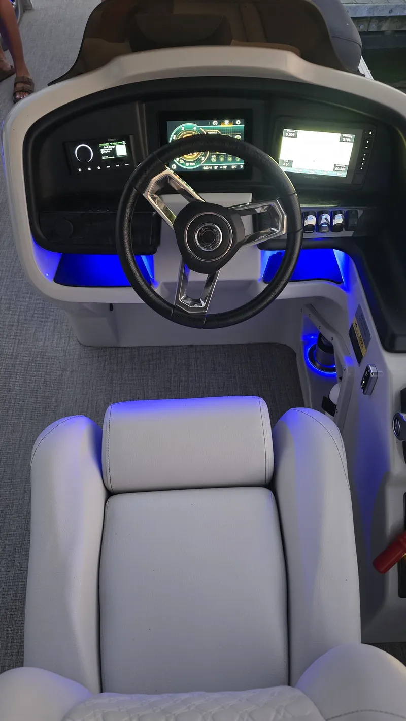 Slide: The Image of The image shows the cockpit of a 2023 Avalon Catalina 2585 CRFS Funship with a modern helm and blue lighting. - 9
