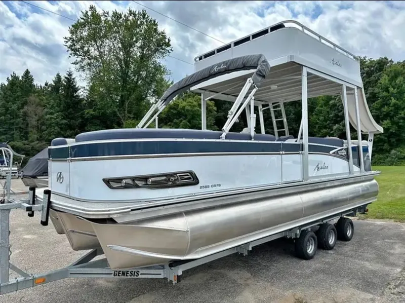 Slide: The Image of 2023 Avalon Catalina 2585 CRFS Funship on a trailer, featuring a two-story design and blue accents. - 1
