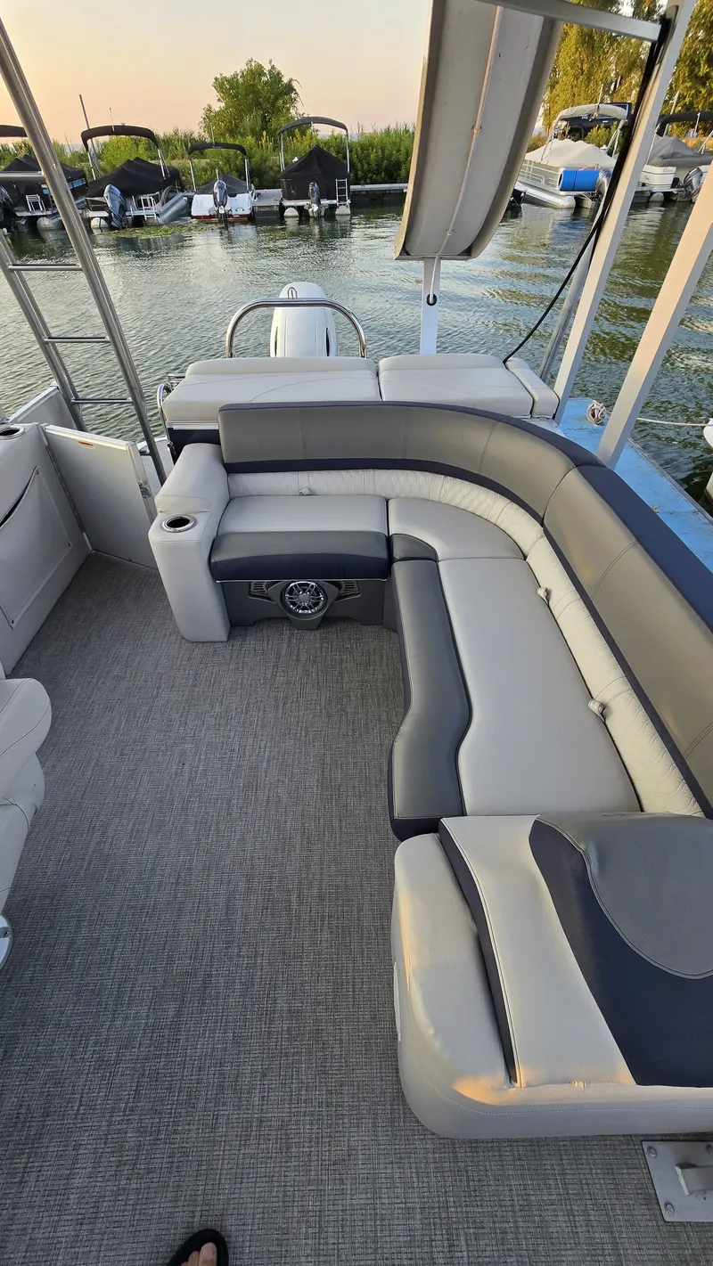 Slide: The Image of The image shows the deck of a 2023 Avalon Catalina 2585 CRFS Funship with gray and white seating. - 13