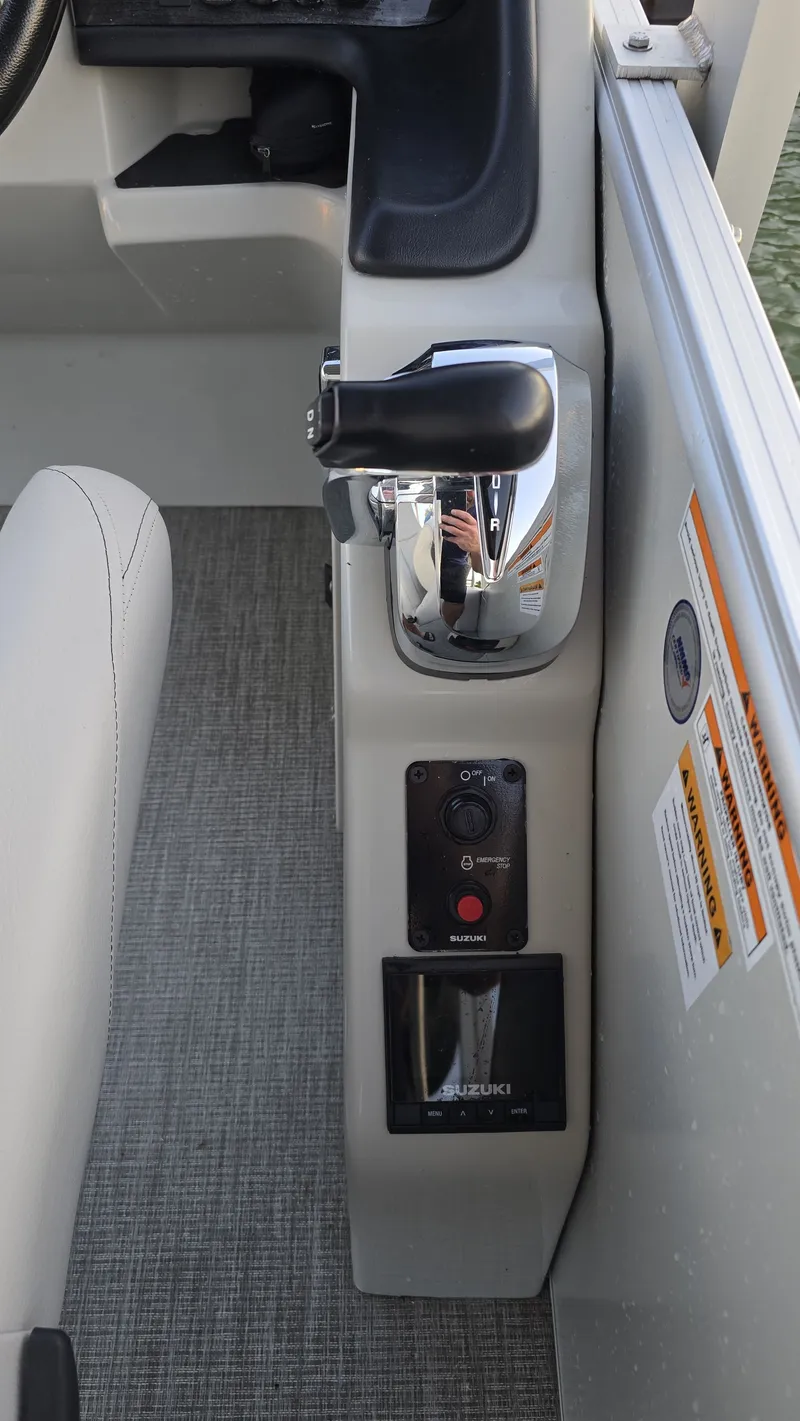 Slide: The Image of Close-up of the control area in an Avalon Catalina 2585 CRFS Funship with Suzuki controls. - 10