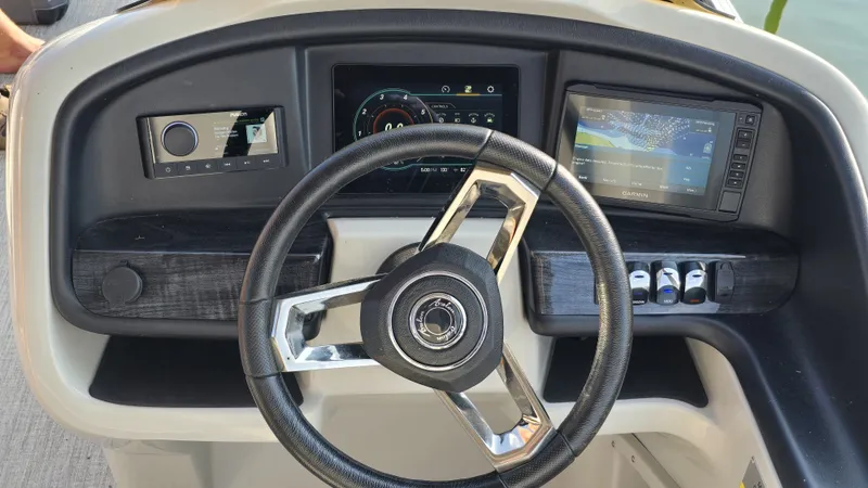 Slide: The Image of The image shows the helm of a 2023 Avalon Catalina 2585 CRFS Funship with modern instruments. - 8