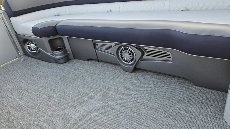 Slide: The Image of Seating area with gray carpet and built-in speakers on a boat. - 15