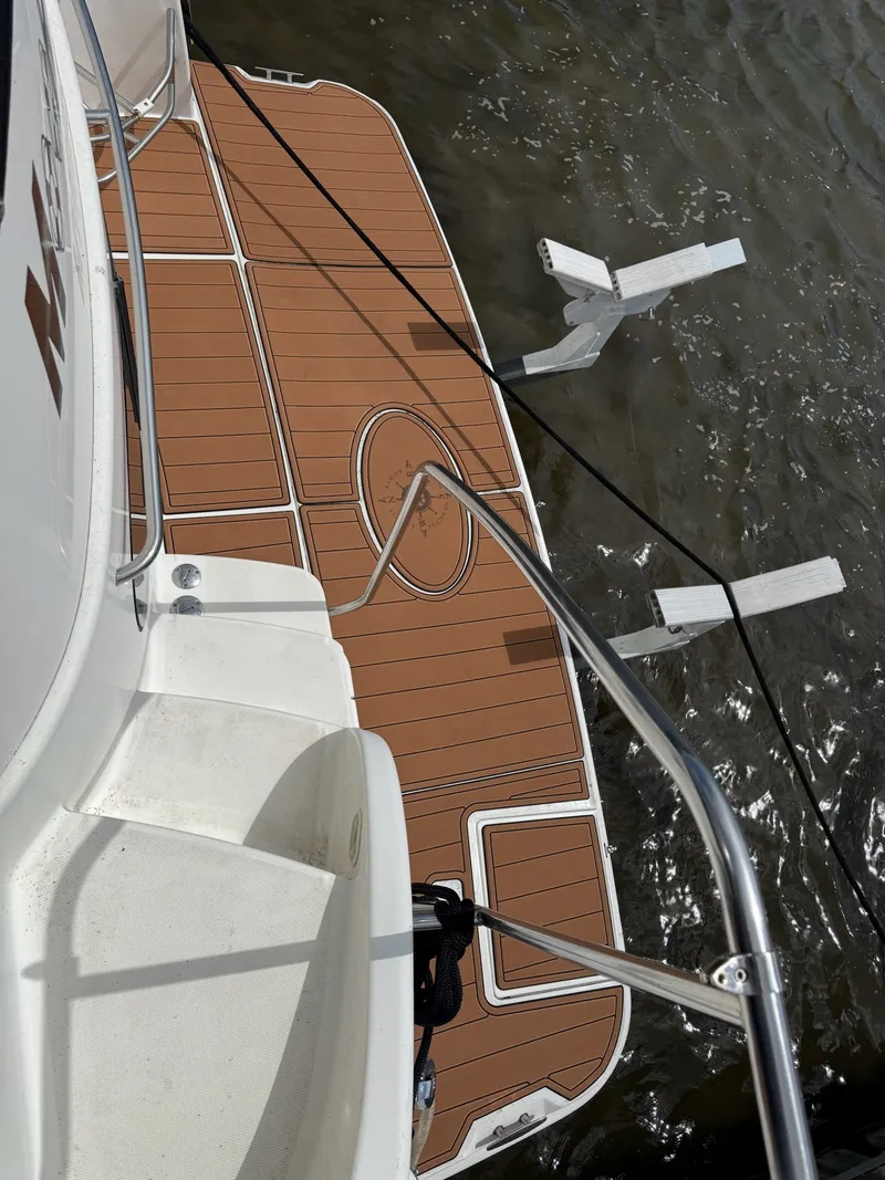 Slide: The Image of The 2004 Silverton 43 Motor Yacht features a sleek teak deck at the stern, hovering over the water. - 18