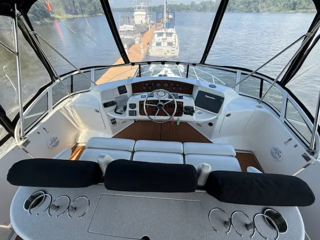 Slide: The Image of The image shows the cockpit of a 2004 Silverton 43 Motor Yacht overlooking the river. - 14