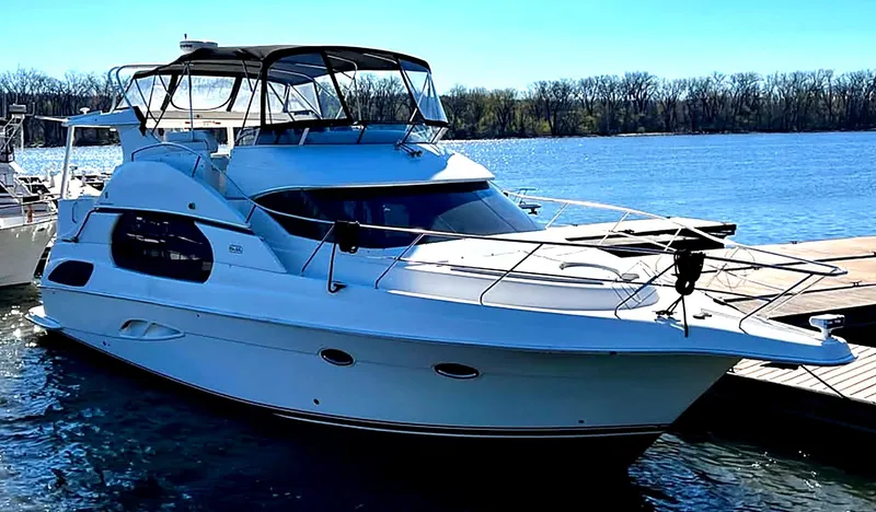The Image of A 2004 Silverton 43 Motor Yacht docked. It features a spacious deck and modern design. - 1