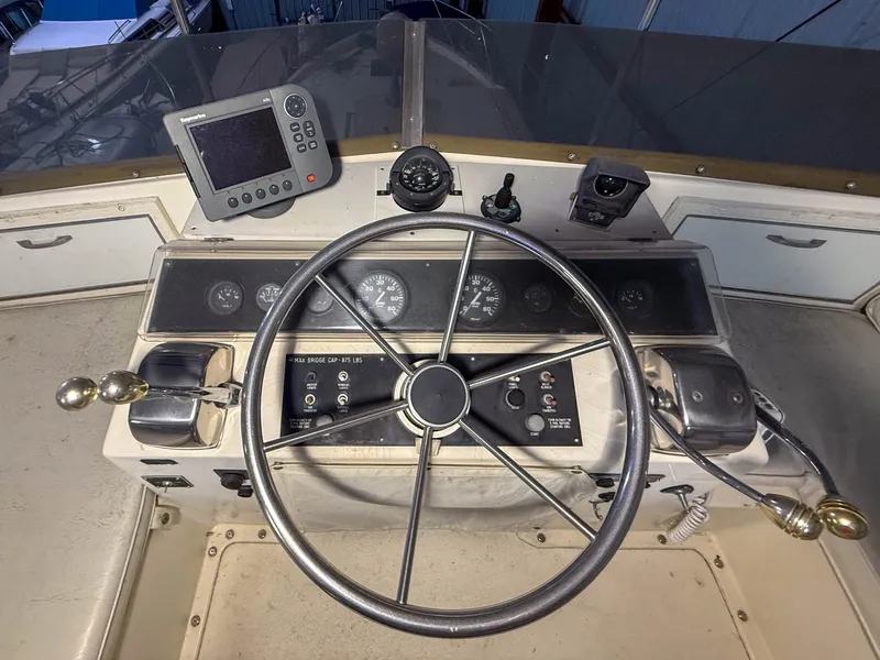 Slide: The Image of The helm of a 1977 Pacemaker FB Motor Yacht with instruments and a navigation system. - 22