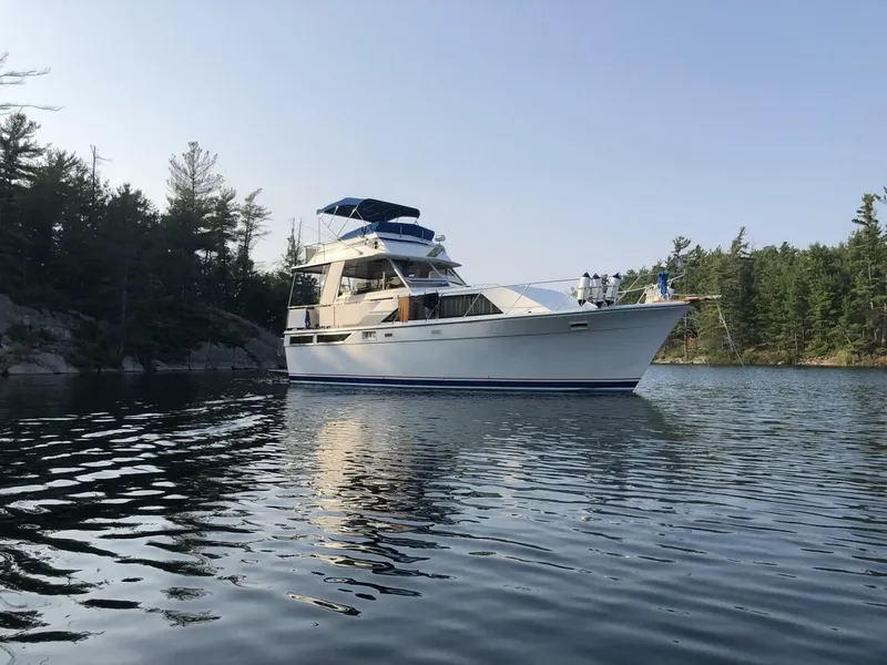 The Image of A 1977 Pacemaker FB Motor Yacht is anchored peacefully in a wooded lake. - 1