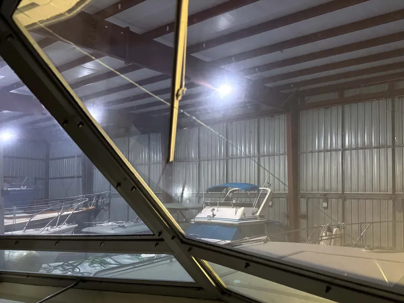 Slide: The Image of Interior view of a boat storage facility with several yachts, including a 1977 Pacemaker FB Motor Yacht. - 16