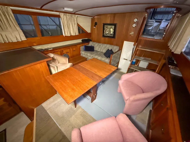 Slide: The Image of Interior of a 1977 Pacemaker FB Motor Yacht with wooden furnishings and cozy seating. - 25