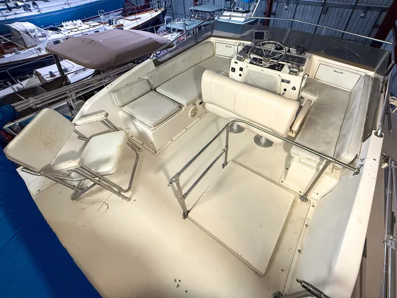 Slide: The Image of The image shows the cockpit of a 1977 Pacemaker FB Motor Yacht with white seating and a helm station. - 20
